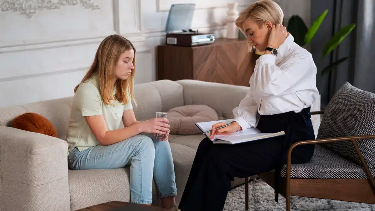 Therapist speaks to a woman holding a glass of water. Text explains the importance of therapy and counseling to avoid relapse