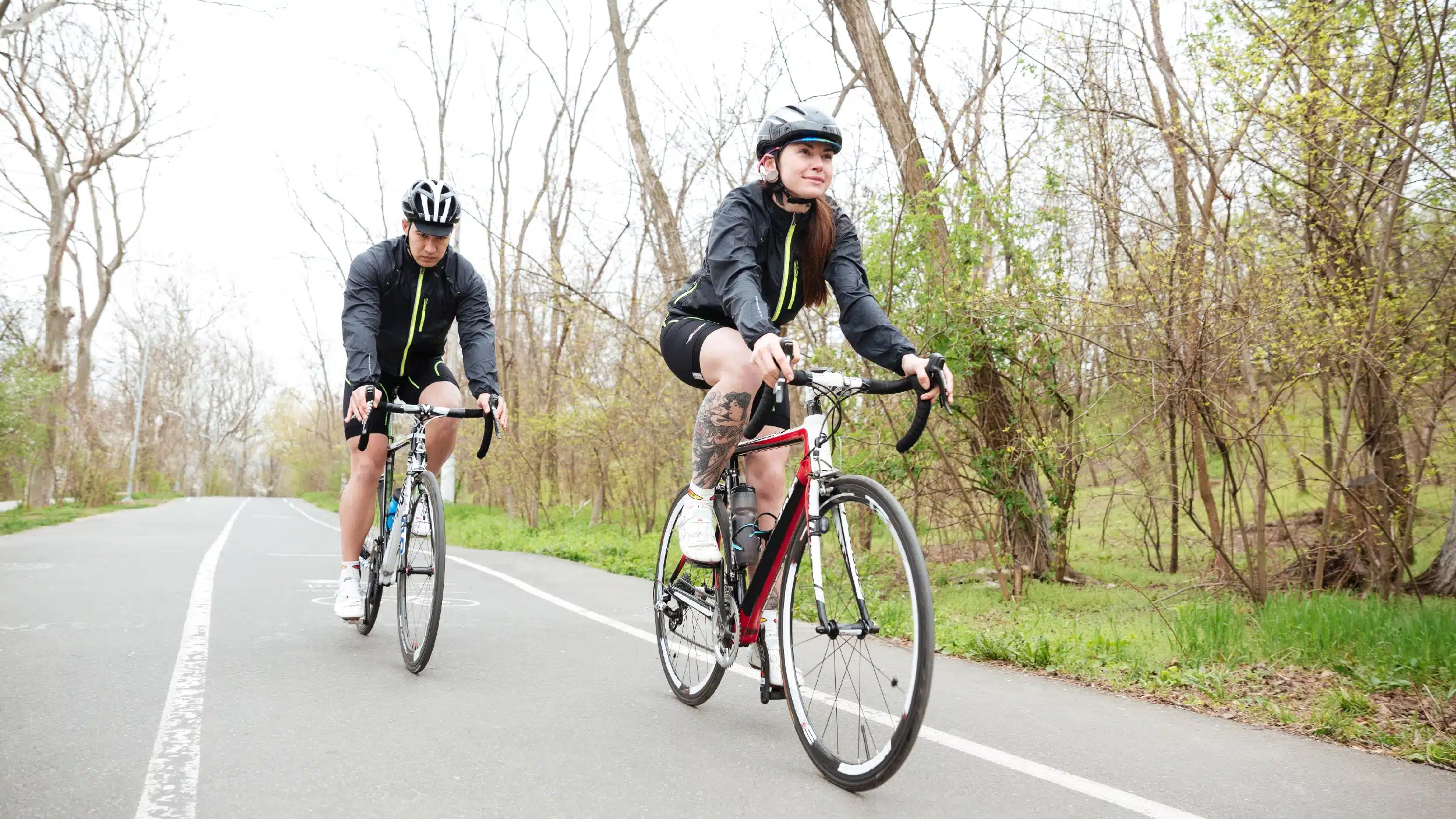 A man and a woman biking on a nature trail. Arkansas offers a diverse range of alternatives for people seeking alcohol-free fun.