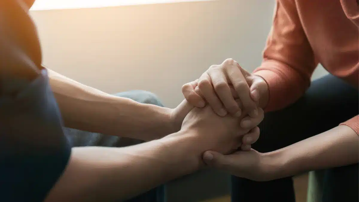 Two people holding hands.