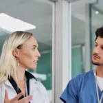 Nurses attentively listening to a doctor explain addiction risks.